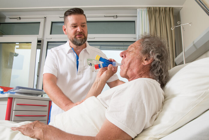 Atemtraining, © Krebsinformationsdienst, DKFZ; Foto: Tobias Schwerdt Ein Patient im Krankenhausbett beim Atemtraining.