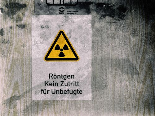 Schild mit Radioaktivitätszeichen: Röntgen, kein Zutritt für Unbefugte.