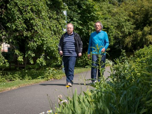 Zwei ältere Männer gehen spazieren. 