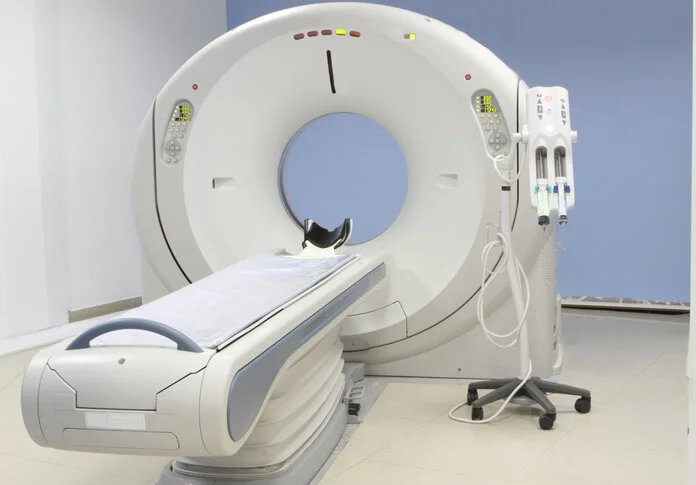 Ein Computertomograph ist ein ringförmiges Untersuchungsgerät mit einer Untersuchungsliege, die den Patient in das Gerät fährt.