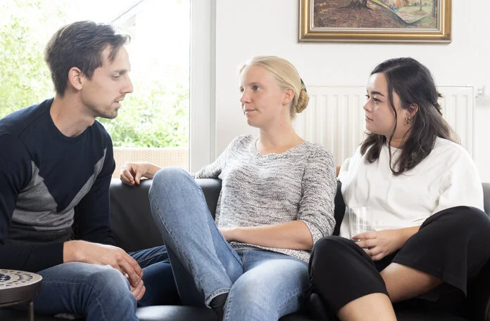 Gespräch zwischen Freunden, Foto: Tobias Schwerdt; © Krebsinformationsdienst, DKFZ Zwei Frauen und ein Mann unterhalten sich auf einer Couch