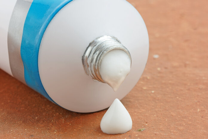 Salbe, © roger ashford, Shutterstock.com Aus einer Tube tropft Salbe auf einen Tisch.